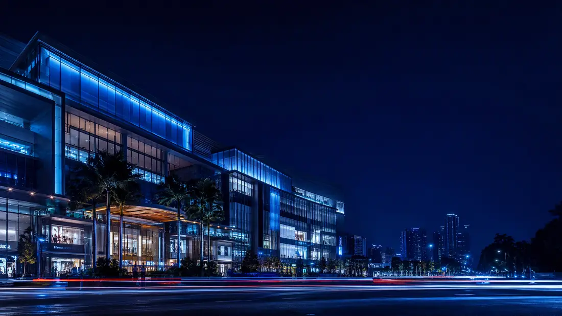 A shopping mall lit up at night